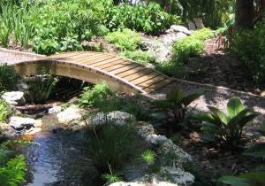 Landscape design featuring a small bridge over a water feature in Key Biscayne, FL